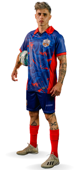 Jogador de futebol com uniforme personalizado azul e vermelho segurando uma bola Jogador de futebol com uniforme personalizado azul e vermelho segurando uma bola